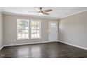 Bright living room with large windows, hardwood flooring, and a ceiling fan at 176 Clear Water Dr, Smithfield, NC 27577