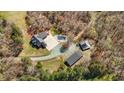 Aerial view of home with a large pool and a shed in a wooded lot at 23901 Nc-902, Bennett, NC 27208