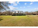 Beautiful home showcasing a metal roof, a well-kept lawn, and curb appeal at 23901 Nc-902, Bennett, NC 27208