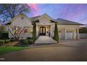 Elegant home exterior showcasing the entrance, manicured landscaping, and brick driveway at 2704 St Marys St, Raleigh, NC 27609