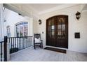 Inviting front porch with arched doors, rocking chair, and classic brick detailing at 2704 St Marys St, Raleigh, NC 27609