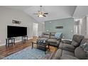 Comfortable living room featuring a ceiling fan, hardwood floors, and ample seating space at 302 Weaver Ridge Rd, Rougemont, NC 27572