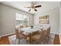 A formal dining room featuring a marble table, seating for six, and a modern ceiling fan at 325 Cobblestone Dr, Spring Lake, NC 28390