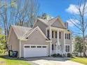 Charming two-story home with a well-manicured lawn, attached two car garage, and welcoming front porch at 3428 Singleleaf Ln, Raleigh, NC 27616