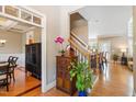 Welcoming foyer with hardwood floors and elegant staircase leading to the upper level at 3504 Griffice Mill Rd, Raleigh, NC 27610