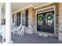 Inviting front porch with rocking chairs, perfect for relaxing and enjoying the outdoors at 3504 Griffice Mill Rd, Raleigh, NC 27610