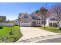 Inviting two-story home with a spacious driveway and a beautifully landscaped front yard at 4005 Freesia Ct, Zebulon, NC 27597