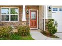 Charming front entrance with stone accents, decorative plants, and a wooden door with decorative glass at 417 Sapphire Rd, Burlington, NC 27215