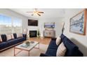 Spacious living room with a fireplace, modern decor, large windows, and ample seating at 417 Sapphire Rd, Burlington, NC 27215