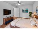 Comfortable bedroom with a ceiling fan, modern decor, and natural light for a relaxing ambiance at 48 Delmar Ct, Fuquay Varina, NC 27526