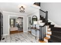 Bright foyer with marble floors, staircase, and an open view to the living room at 509 Queensferry Rd, Cary, NC 27511