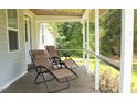 Relaxing porch with two lounge chairs, perfect for enjoying the peaceful outdoor scenery at 529 Flanagan Rd, Henderson, NC 27537