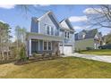 Charming two-story home with a two-car garage and a well-manicured front yard at 604 Whistable Ave, Wake Forest, NC 27587