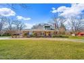 Charming brick home with well-manicured lawn and mature trees on a sunny day at 712 Springwood Ave, Gibsonville, NC 27249