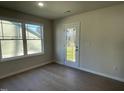 Bright room with hardwood floors and a glass door leading outside, providing natural light and easy access at 72 Heatherglenn Cir, Princeton, NC 27569