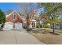 Charming brick home featuring a two-car garage and well-maintained landscaping at 7604 Derek Dr, Raleigh, NC 27613