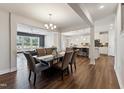 Open dining area with elegant chandelier and flows into the living room and kitchen at 803 Toulouse Ct, Cary, NC 27519