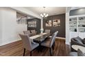 Open dining room with gray walls and a modern table set, adjacent to living area at 803 Toulouse Ct, Cary, NC 27519