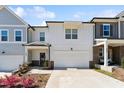 Charming townhome showcasing modern design, front yard landscaping, and attached garage at 803 Toulouse Ct, Cary, NC 27519