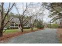 Charming single-Gathering home with a welcoming front porch and a gravel driveway surrounded by trees at 8504 Old Nc 86, Chapel Hill, NC 27516