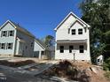 Exterior showing white siding, black roof, and concrete driveway at 908 Colfax St, Durham, NC 27701
