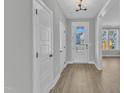 Bright entryway with light walls, wood-look floors, coat closet, and a front door with glass panels at 9152 Dupree Meadow Dr # 12, Angier, NC 27501
