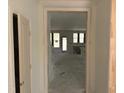 Unfinished living room with many windows, fireplace, and open floorplan to kitchen at 9152 Dupree Meadow Dr # 12, Angier, NC 27501