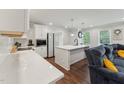 Bright kitchen featuring an island with a sink and stainless steel appliances, and hardwood floors at 1001 Helms Pl, Raleigh, NC 27610