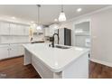 Bright kitchen with a large white island, stainless steel appliances, and pendant lighting at 1001 Helms Pl, Raleigh, NC 27610