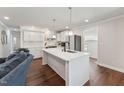 Bright kitchen with a large white island, stainless steel appliances, and pendant lighting at 1001 Helms Pl, Raleigh, NC 27610