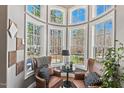 Charming sitting area with cozy chairs and windows with views of the landscaped front yard at 119 November Dr, Durham, NC 27712