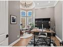 Bright office space featuring large windows, wood floors, a chandelier, and a vaulted ceiling at 119 November Dr, Durham, NC 27712