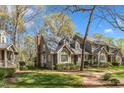 Townhome showcasing lush landscaping and brick walkway leading to the entrance at 131 Long Shadow Ln, Cary, NC 27518