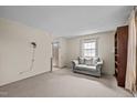 Open living room layout featuring neutral carpet and natural light at 1507 Ridgeway Ave, Durham, NC 27701