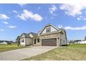 Charming two-story home featuring stone accents, a two-car garage, and a beautifully landscaped front yard at 151 S Harper Faith Way, Benson, NC 27504