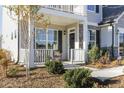 Charming covered front porch offers a cozy seating area and attractive landscaping at 1515 Willbrook Dr, Fuquay Varina, NC 27526