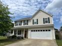 Charming two-story home with a well-manicured lawn and attached two car garage at 1643 Southcross St, Fuquay Varina, NC 27526