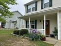 Welcoming front porch with beautiful landscaping, flowers and white railings at 1643 Southcross St, Fuquay Varina, NC 27526