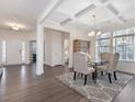 Dining area with coffered ceilings, hardwood floors, and view of the large front windows at 182 Mill Bend Dr, Fuquay Varina, NC 27526