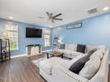 Bright living room featuring a ceiling fan, hardwood floors, and plenty of natural light at 182 Mill Bend Dr, Fuquay Varina, NC 27526