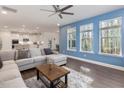 Bright living room featuring a ceiling fan, hardwood floors, and lots of natural light at 182 Mill Bend Dr, Fuquay Varina, NC 27526