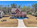 Expansive view of a two-story home with a three-car garage on a sprawling lot at 182 Prince Place Dr, Fuquay Varina, NC 27526