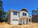 Charming two-story home with a covered porch and a one car garage at 187 Regis Ln # 10, Coats, NC 27521