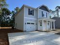 Two-story home with a one-car garage, newly installed vinyl siding, and a concrete driveway at 187 Regis Ln # 10, Coats, NC 27521