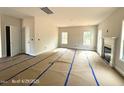Bright living room featuring a fireplace and multiple windows at 187 Regis Ln # 10, Coats, NC 27521