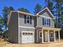 Attractive two-story home with a front-facing garage and covered porch at 205 Regis Ln # 11, Coats, NC 27521