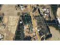 Aerial view of land for sale, highlighted in blue, surrounded by a mix of wooded areas and neighboring properties at 205 Regis Ln # 11, Coats, NC 27521