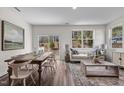 Bright open-concept living and dining room with a rustic wood table, comfortable seating, and natural light at 2123 Trailside Dr, Durham, NC 27704