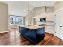 Open kitchen with an island, modern lighting, and stainless steel appliances at 220 Shawnee Dr, Louisburg, NC 27549