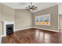 Spacious living room featuring a fireplace, hardwood floors, and a ceiling fan at 220 Shawnee Dr, Louisburg, NC 27549